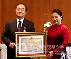2018년 12월 베트남 정부를 대신해 응우옌티낌응언 베트남 국회의장으로부터 정부 훈장을 받은 안경환 편집주간